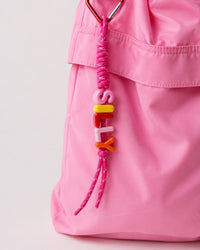 Silly Unicorn Keychain on a pink gingham bag