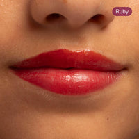Girl wearing Silly Unicorn Doudou Lips lip oil in Ruby